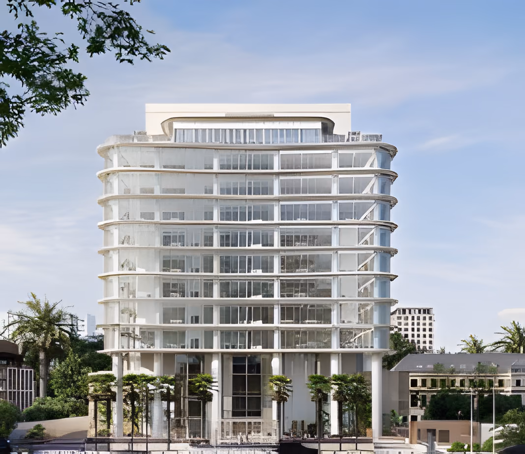 Twelve-storey white office building with curved, glazed floors