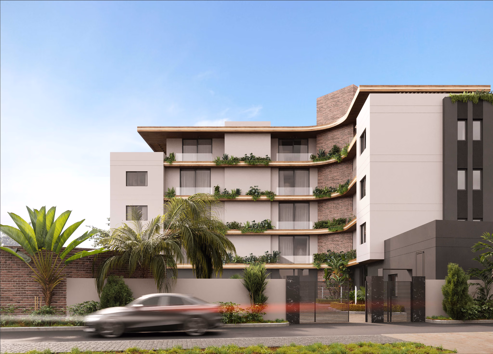 A block of flats from the street, behind palms and a boundary wall
